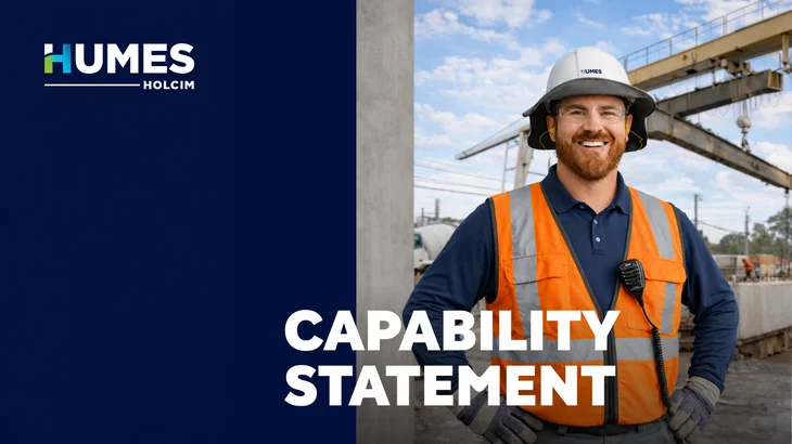 Cover of the Humes Capability Statement showing a smiling Humes worker in a hard hat and hi-vis vest at a precast yard with a gantry crane.